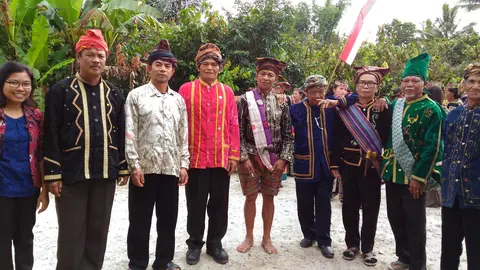 Yenny taking picture with the elders from each village with their customary clothes